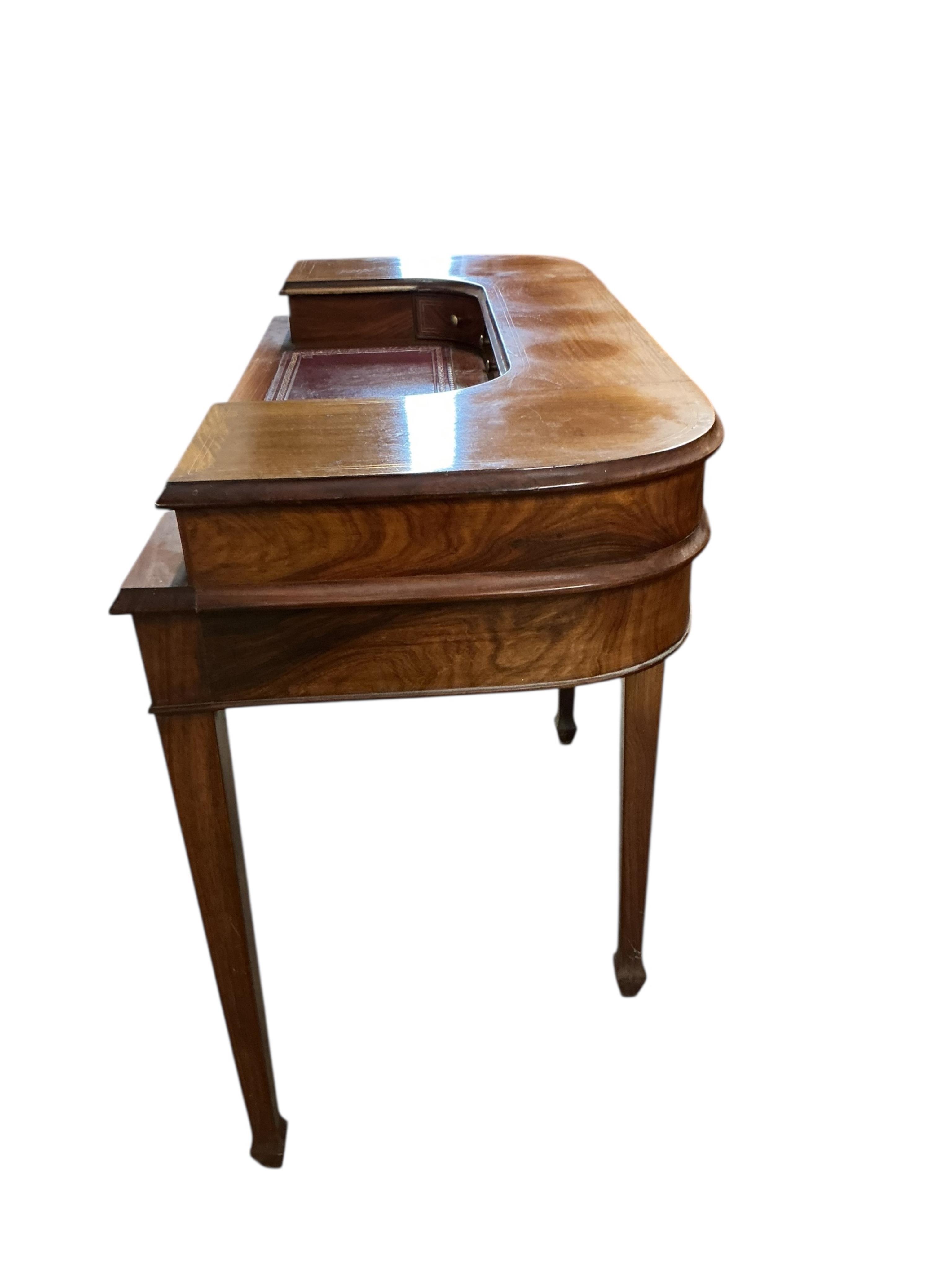 A reproduction brass inlaid mahogany Carlton House type desk, width 116cm, depth 54cm, height 87cm